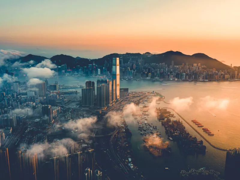 Aerial view of a connected smart city at sunrise, illustrating Axis Communications’ intelligent traffic solutions for data-driven mobility, urban safety, and efficient transportation management.