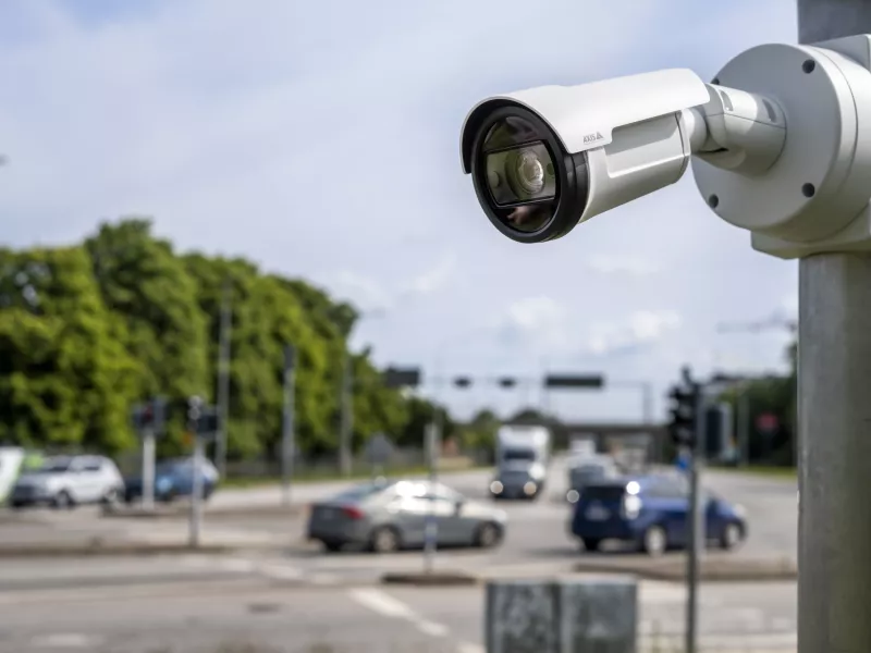 Camera mounted on pole with blurred traffic in the background