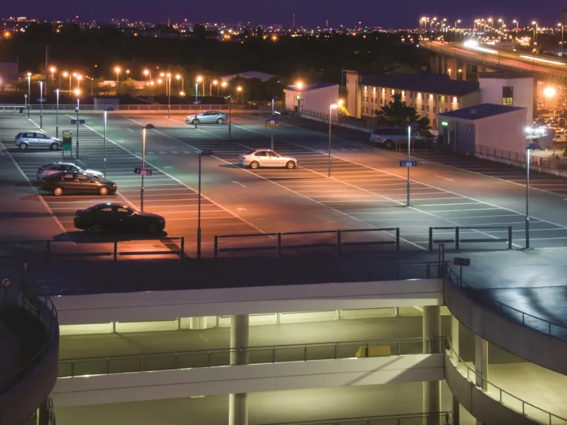 Overview a parking structure during nighttime. 