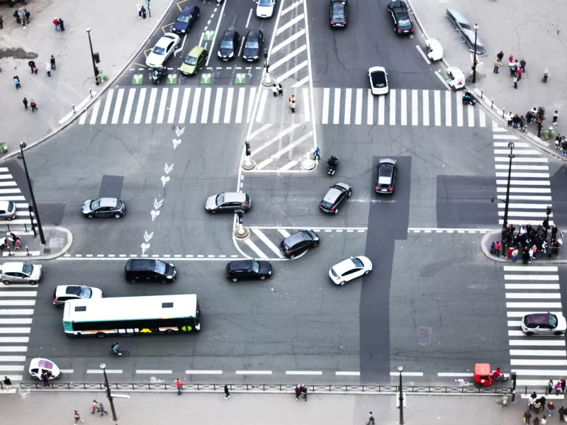 Smart traffic management at a busy urban intersection with cars, buses, cyclists, and pedestrians — showcasing the importance of intelligent traffic monitoring, intersection safety, and real-time video analytics for modern cities.
