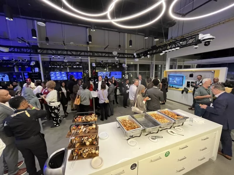 Attendees networking at the Atlanta Axis Experience Center during the ASIS Mixer event.