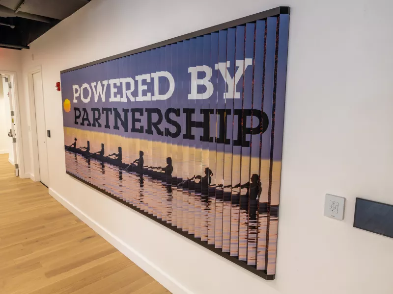 Boston Axis Experience Center Lenticular Wall Display highlighting Axis partnerships and collaboration as the foundation for shared success.