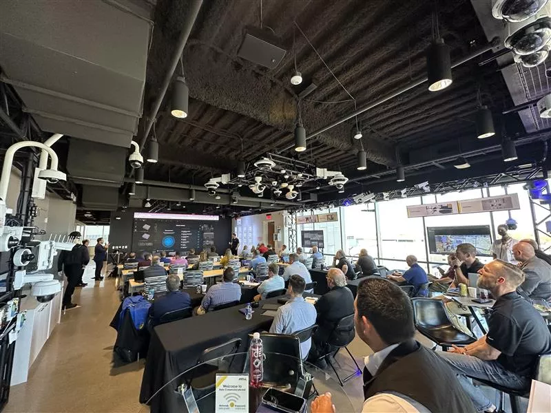 Axis and Genetec roadshow showcasing integrated security solutions, including video surveillance, access control, and interactive technology demonstrations.