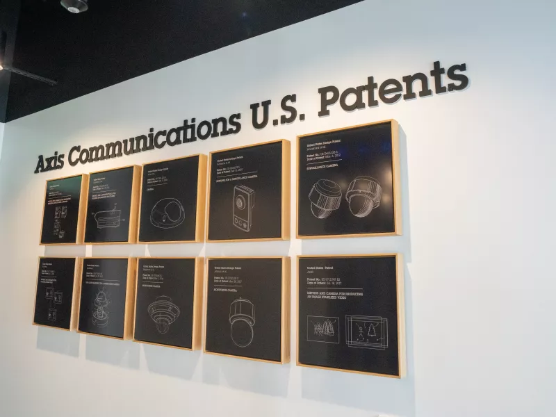 Dallas Axis Experience Center U.S. Patents Wall highlighting Axis Communications innovations and patented technologies in network security solutions.