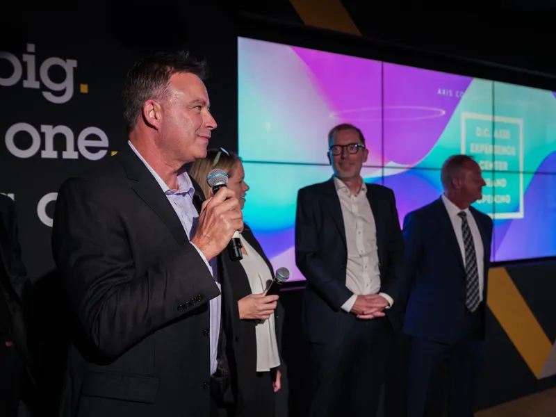 DC Axis Experience Center grand opening celebration with guests and ribbon-cutting