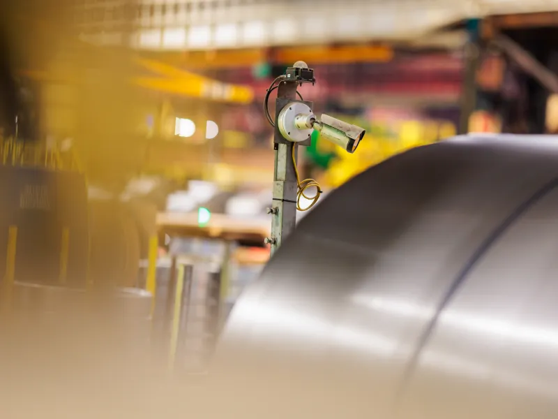 Camera pointed to a roll of steel sheets