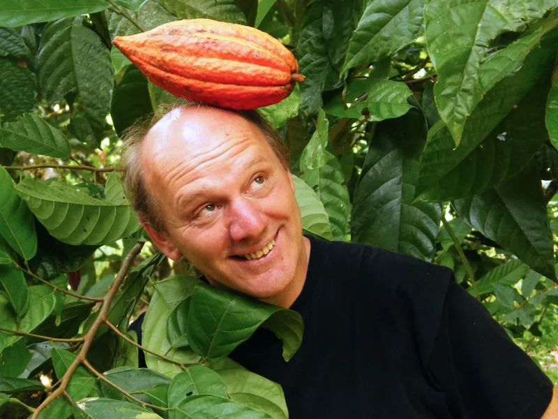 Man with coca bean on top of his head in a djungle