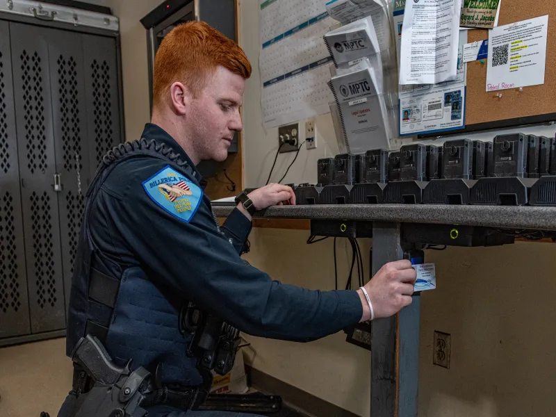 Officer using card reader to assign camera