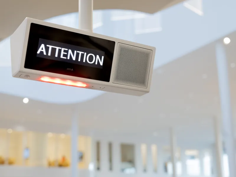 An AXIS C1720 Network Display Speaker with the message Attention