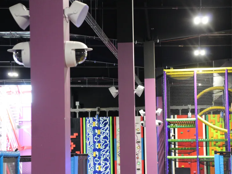 Interior view with Axis cameras and speakers mounted on purple column