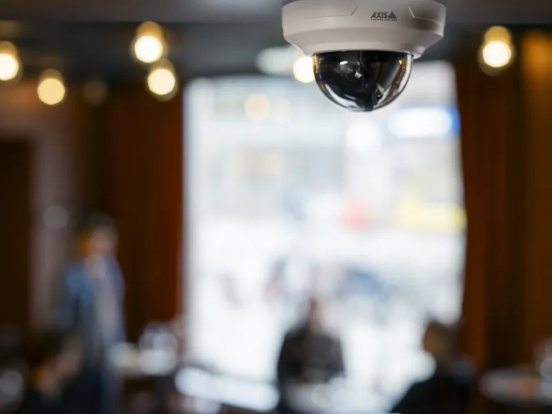 White dome camera ceiling mounted in a store 