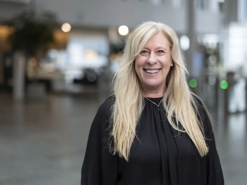 Malin Svensson standing in front of the camera smiling