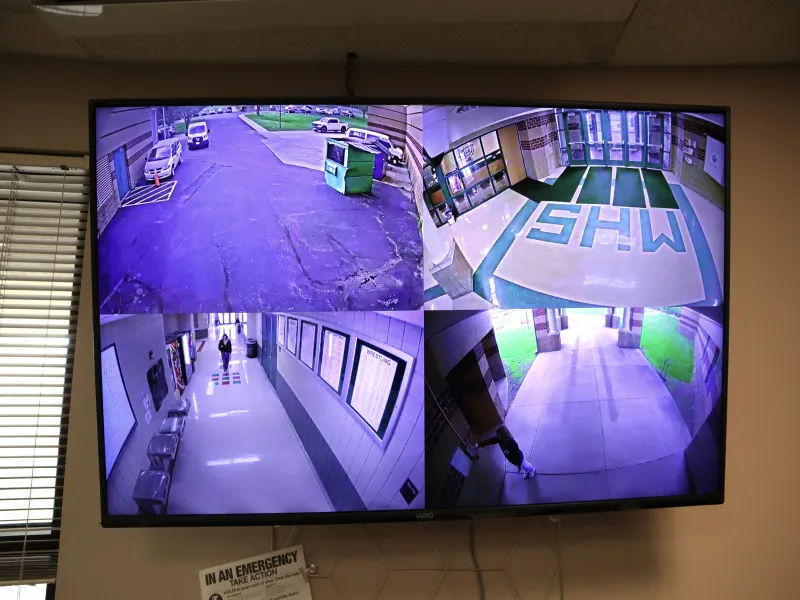 Quad monitor showing video streams of entrances