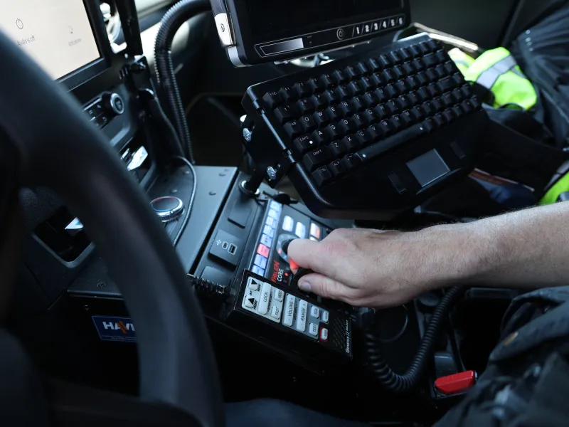 Patrolman activates lightbar from inside cruiser