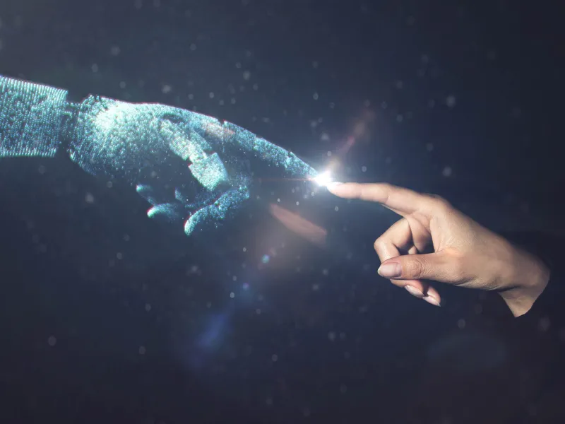 Human hand touching ai robot hand