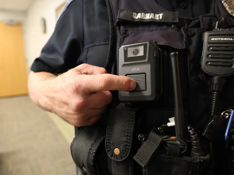 Patrolman manually activating Axis body worn camera