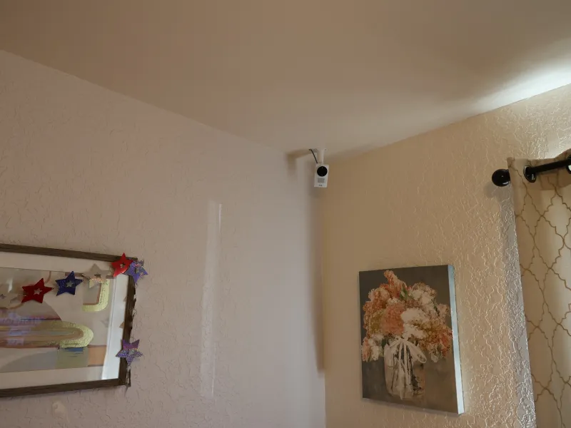Axis box camera in upper corner of resident's room