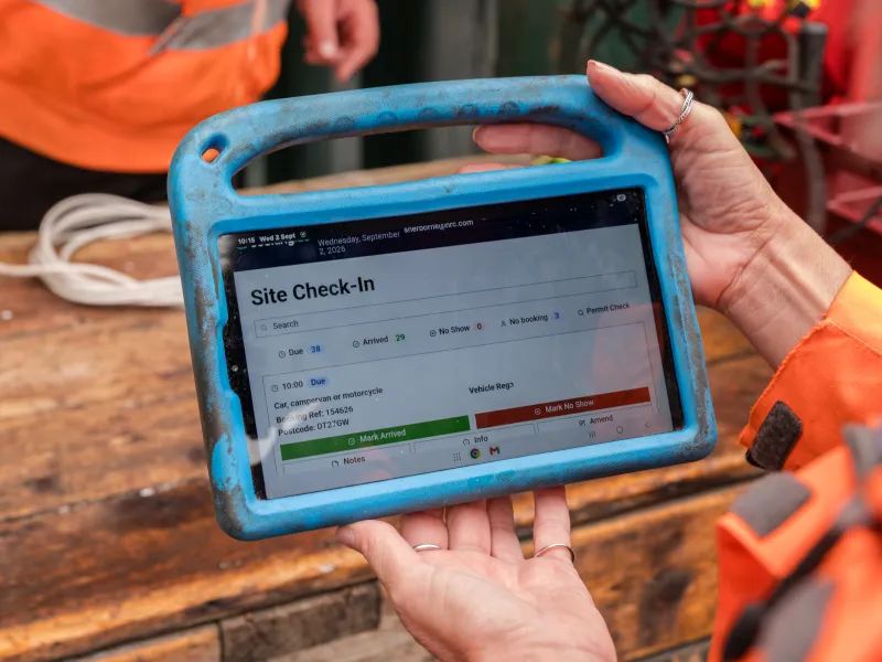 Tablet displaying a site check-in dashboard used by recycling centre staff