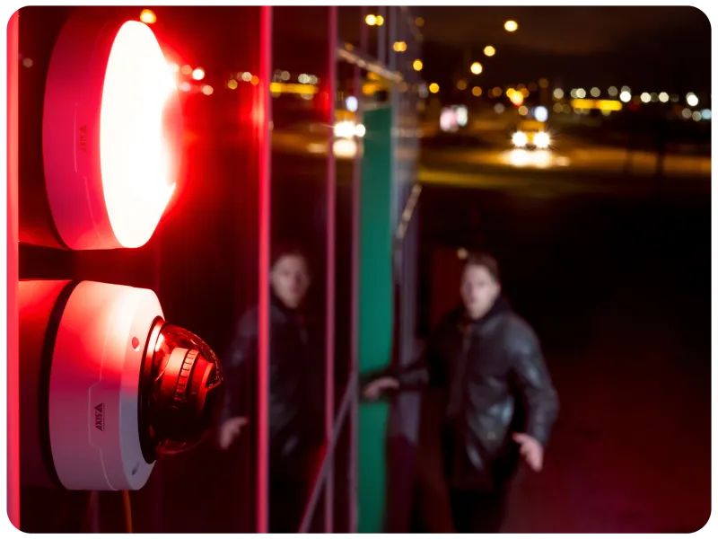 A camera and red strobe light warning a potential intruder.