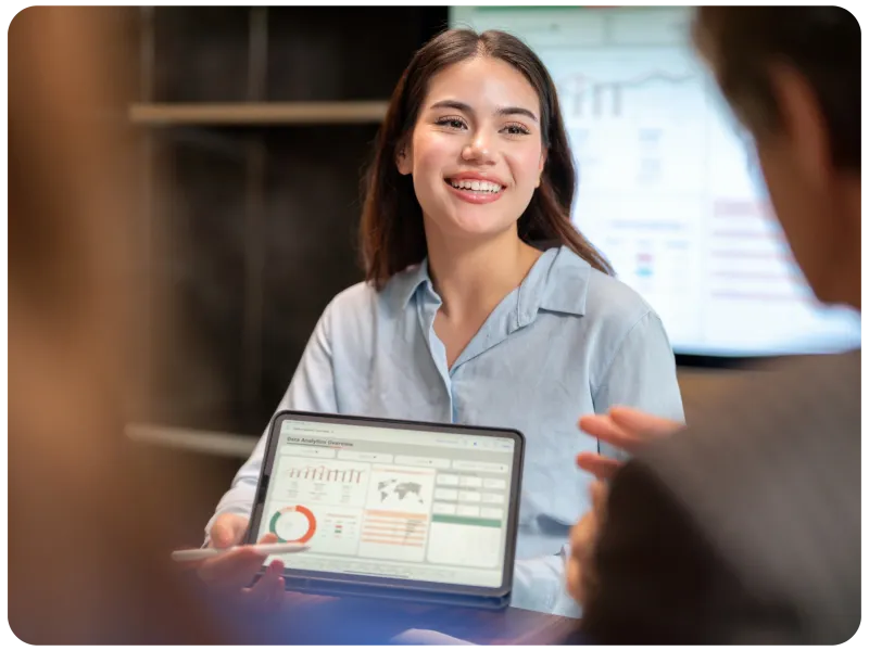 Woman with laptop showing dashboard screen.
