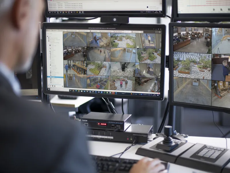 Man viewing the video surveillance on monitors