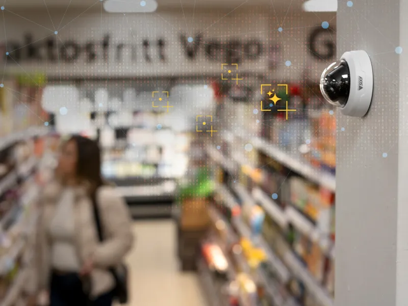 AXIS F4108 mounted on a wall in a grocery store.