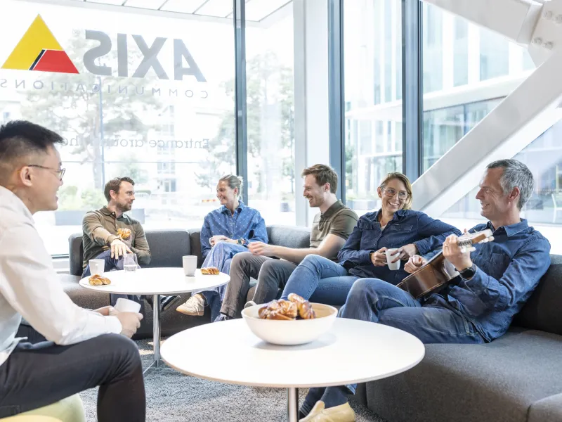 group of colleagues talking in lounge area