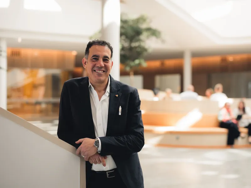 Axis employee Djamel Iabani standing by the stairs at Grenden, Axis HQ, in Lund.