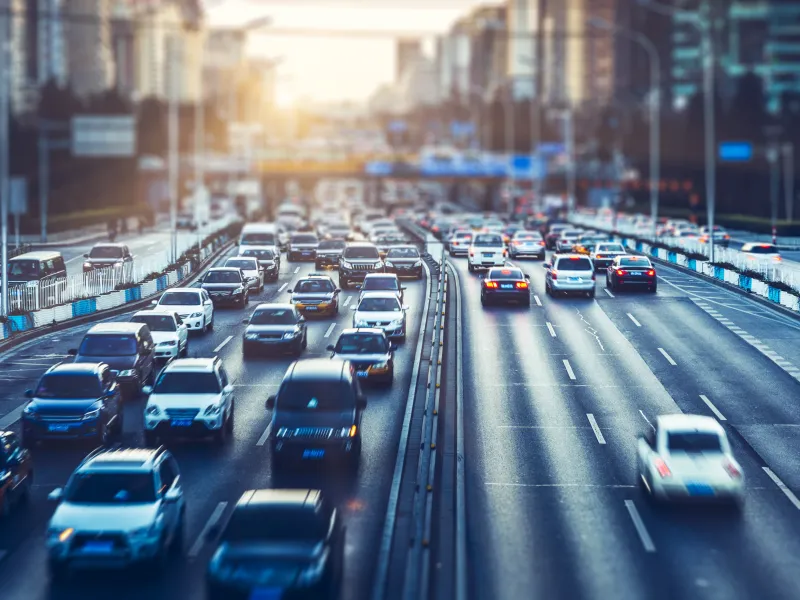 Aerial view of two busy highways with vehicle on the left and right lane.
