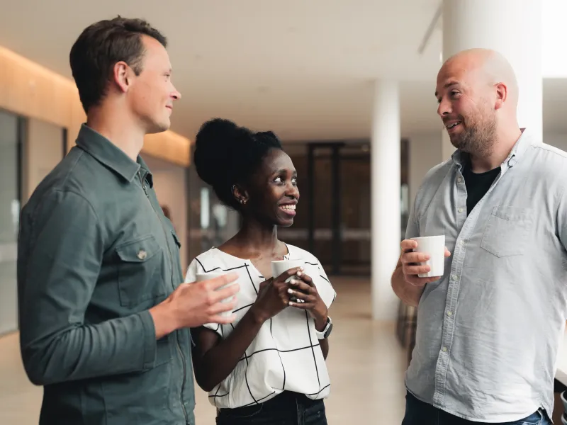 Axis colleagues chatting over a cup of coffee at the headquarters in Lund.