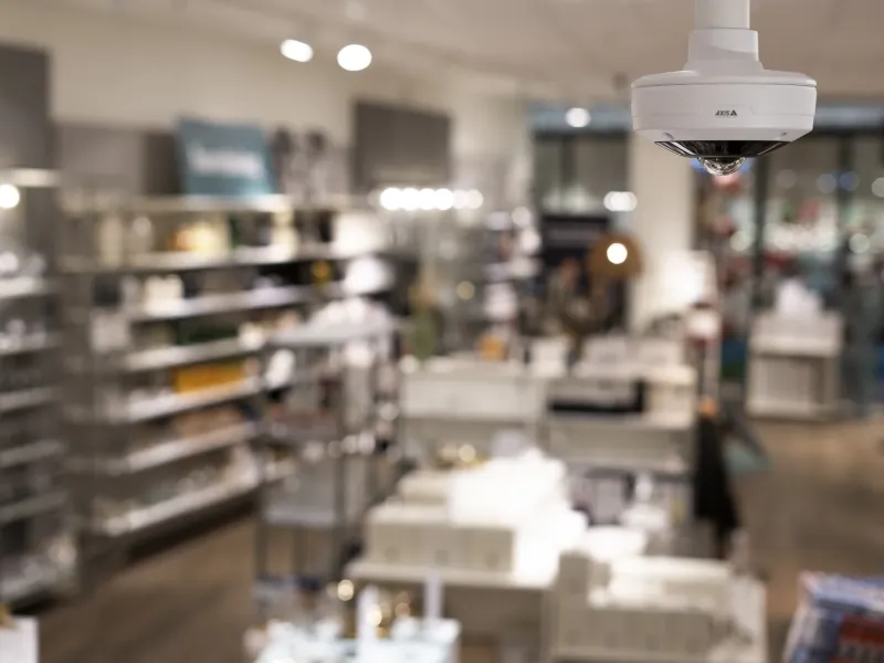 AXIS M4317 mounted on the ceiling to monitor a retail store.