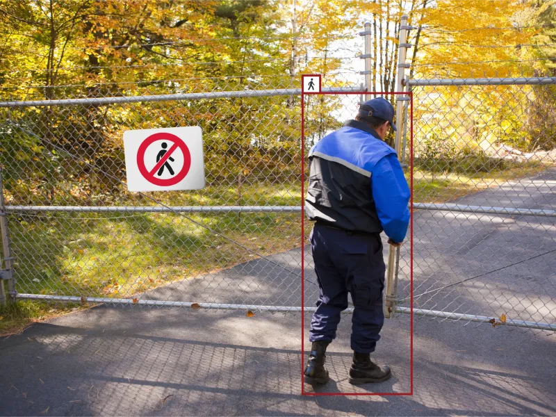 An intruder trespassing a gated area caught on a security camera with AXIS Object Analytics.