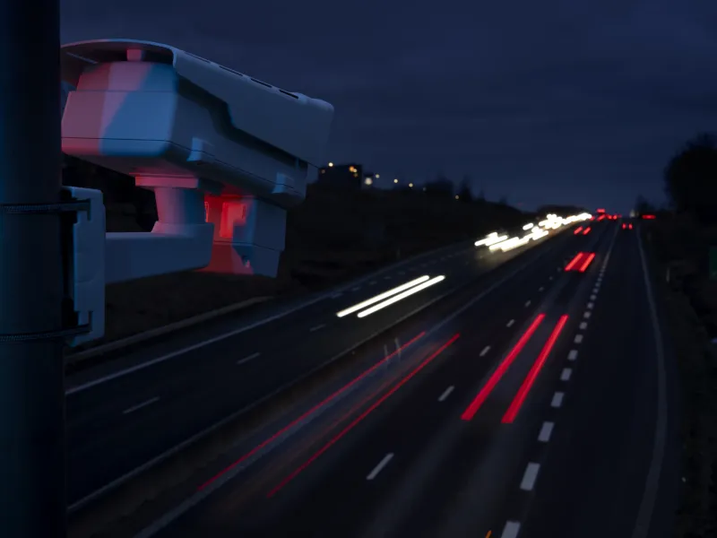 AXIS Q1686-DLE mounted on top of a highway to monitor traffic and hazardous vehicles during nighttime.