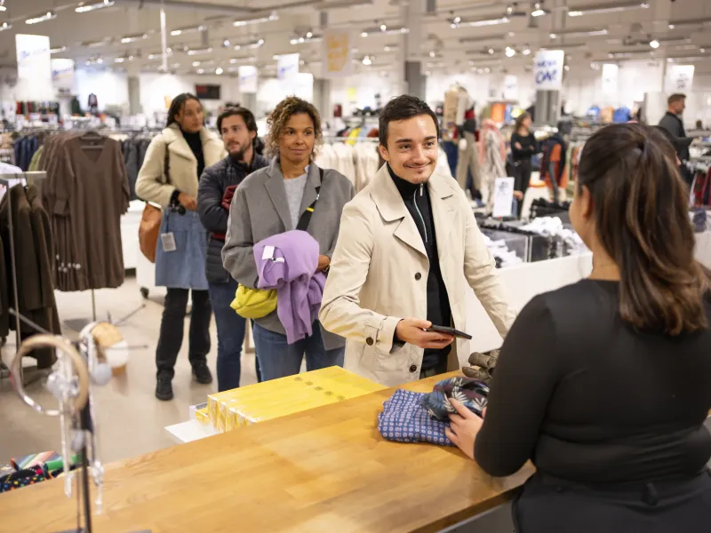 A queue of customers in front of the checkout desk.