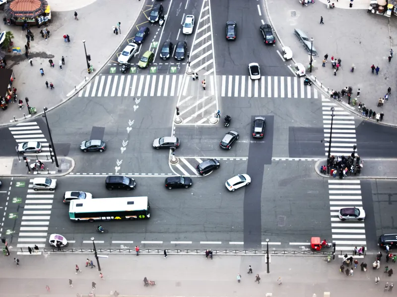 Busy traffic intersection with crosswalks from an aerial view. 