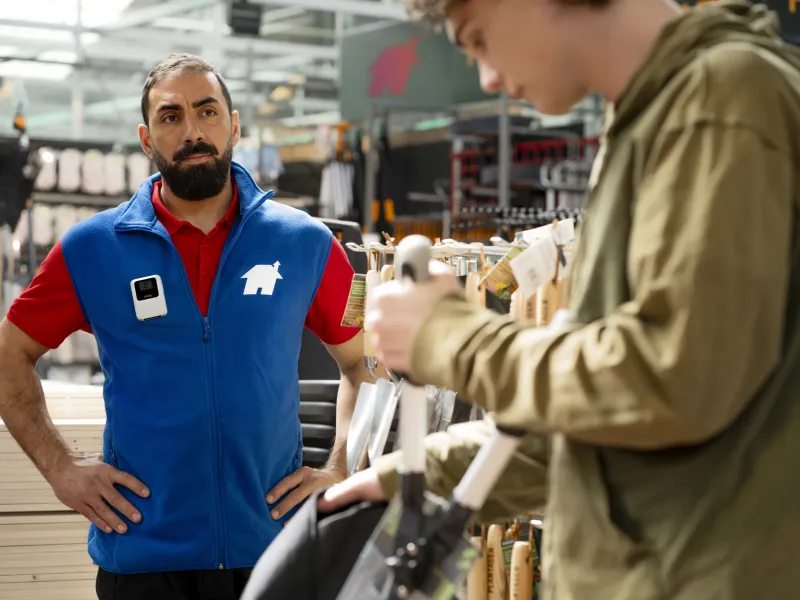 Manager, with a body worn camera on his vest, observing theft in the store.