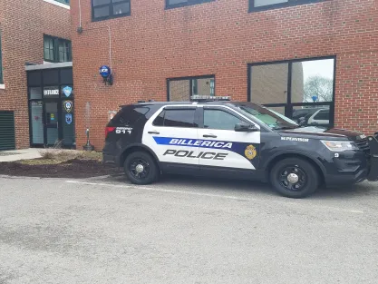 Exterior of Billerica, MA police department with police car