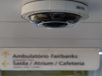 Ceiling camera in foreground with hospital sign in background