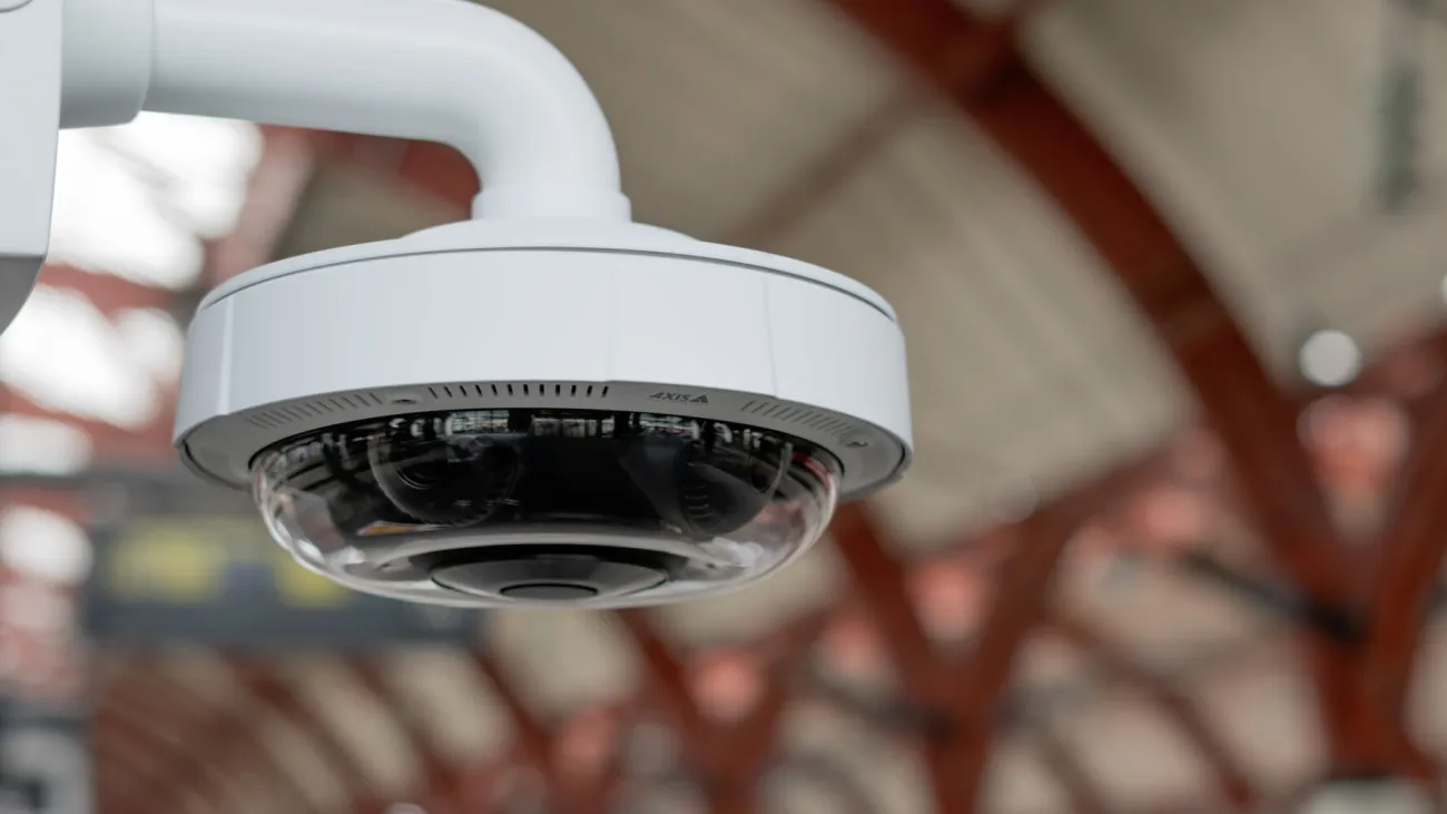 Axis network camera mounted on a pole by a train station platform-