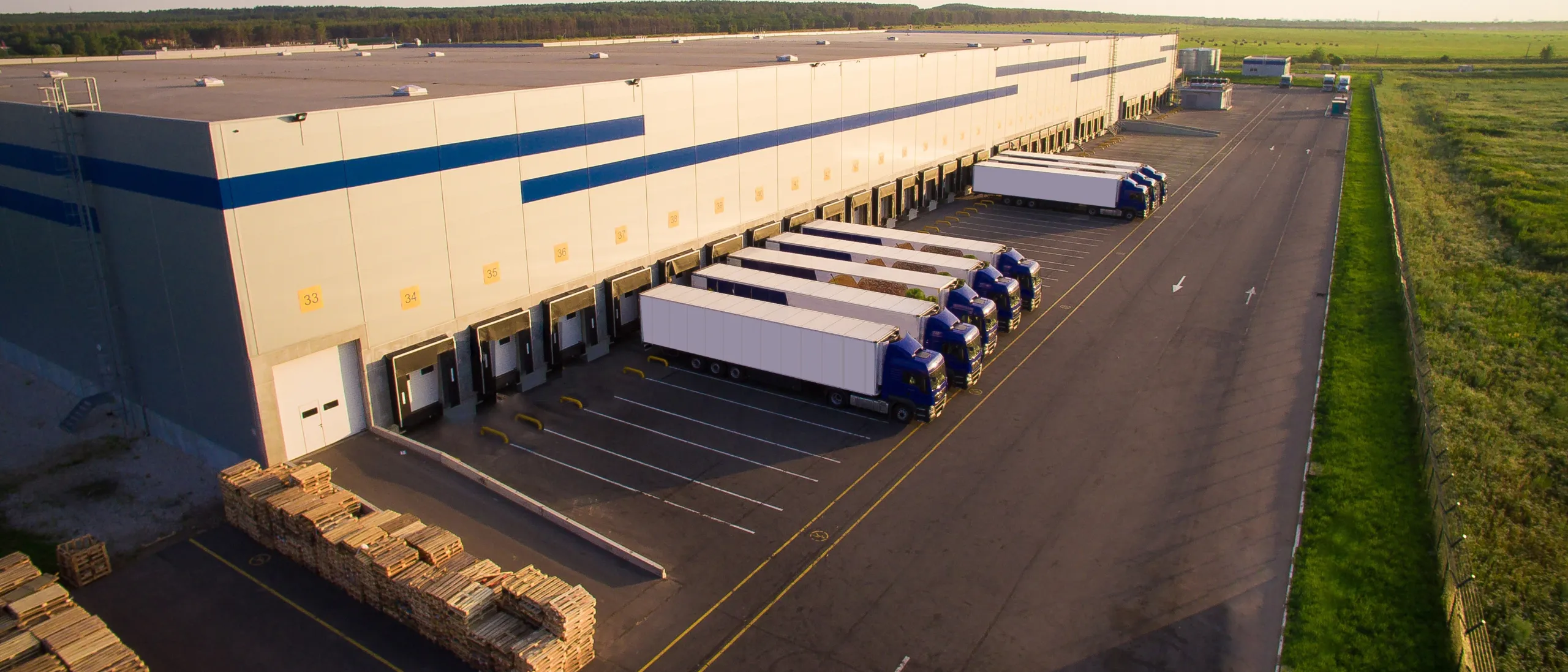 Aerial view of trucks loading at a logistics center.