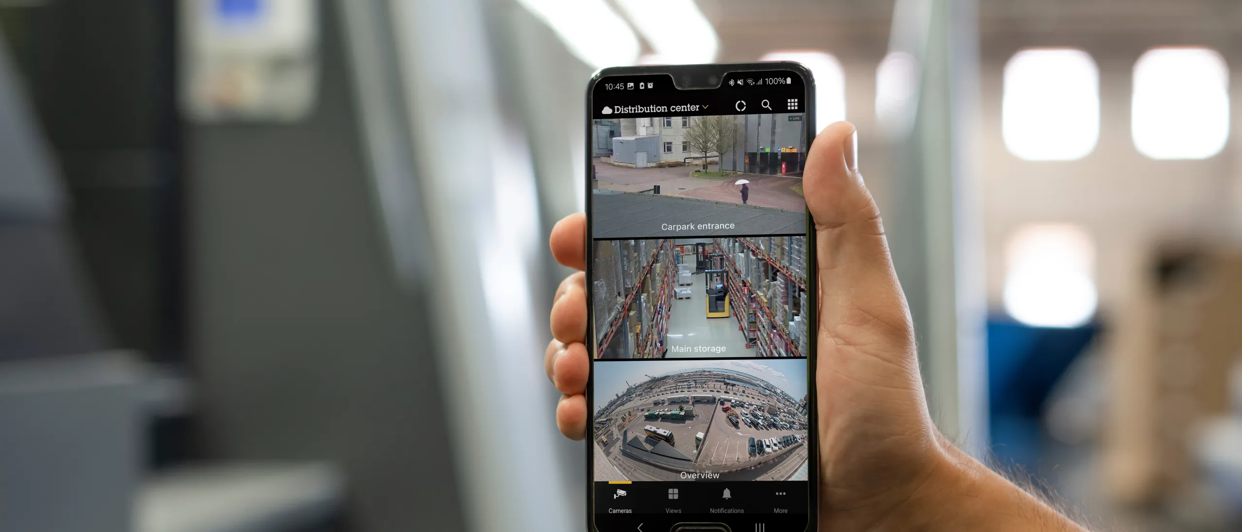 A phone held by a person to show AXIS Camera Station Pro's features all in one place.