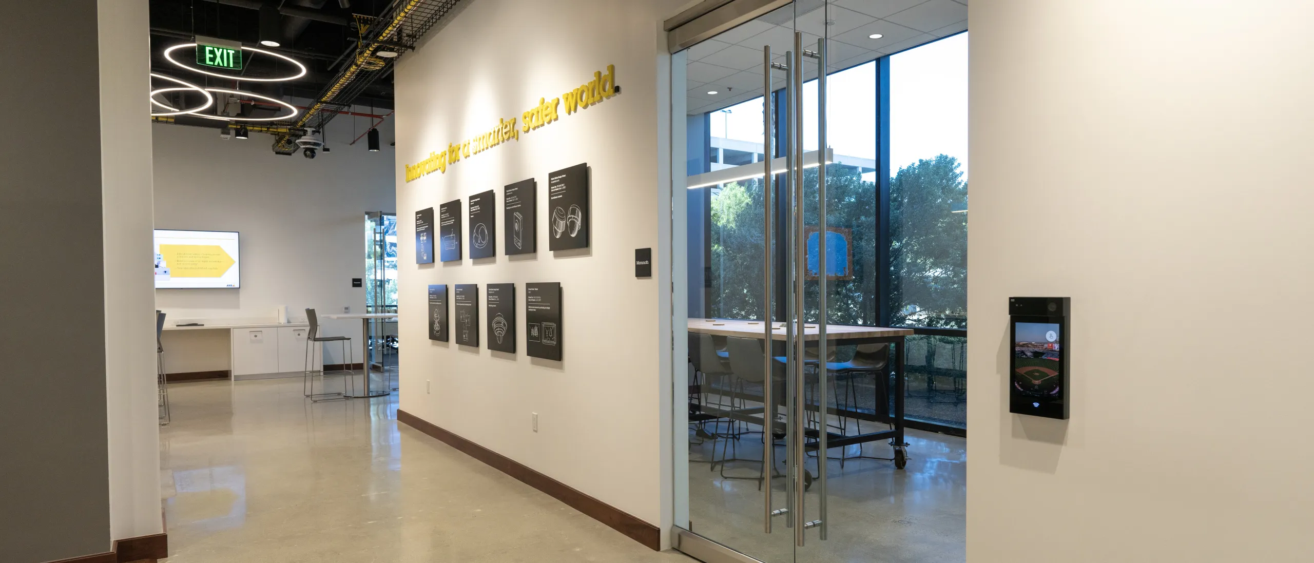 Hallway in the AEC of Irvine with paintings of Axis products on the wall.