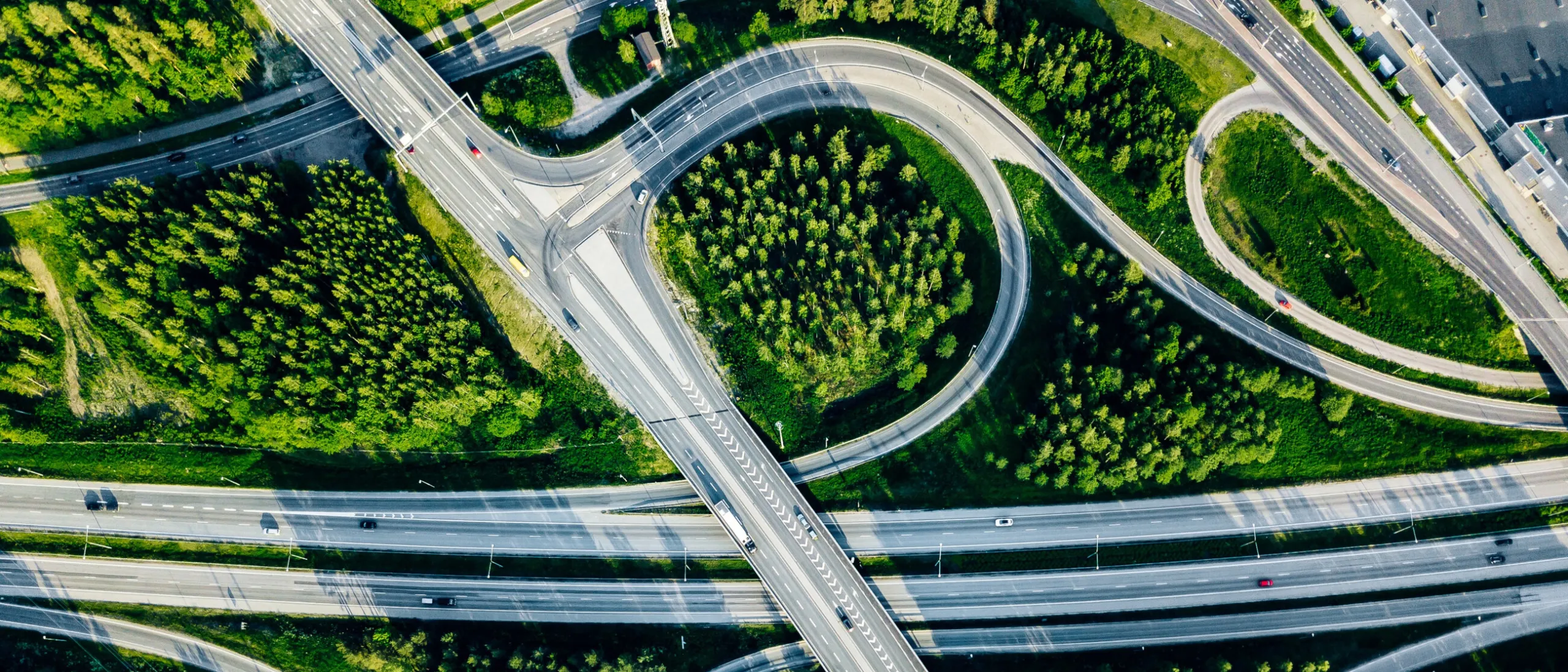 Aerial view of a highway overpass surrounded by greenery.