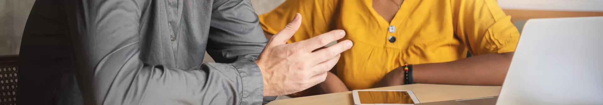 Man and woman discussing at a table
