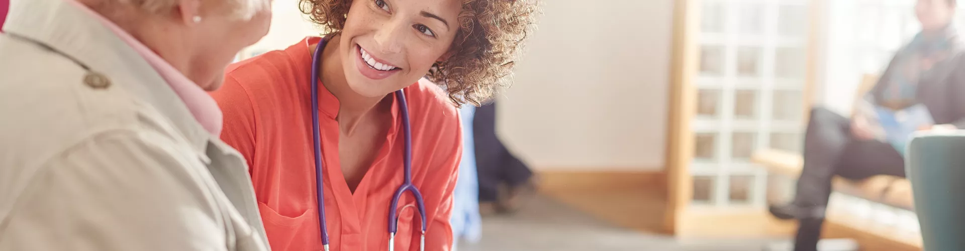Woman doctor consulting elderly woman patient