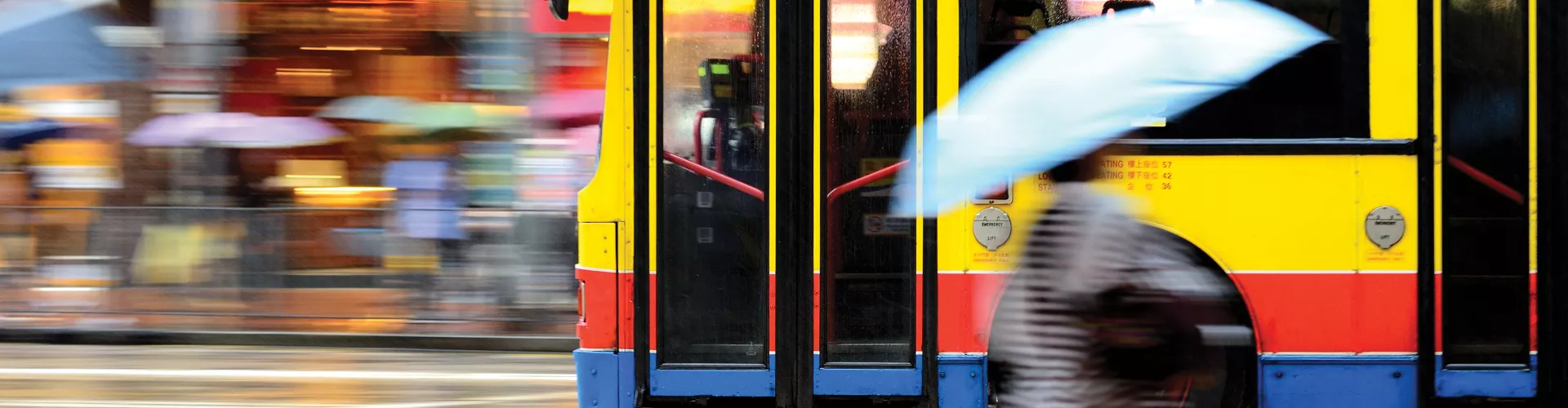 Blurry picture of bus passing by on  a street