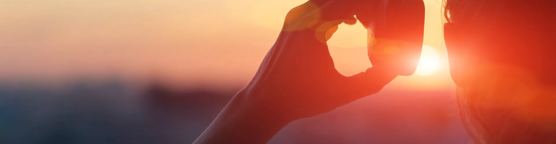 silhouette of a woman with headphone in front of a sunset