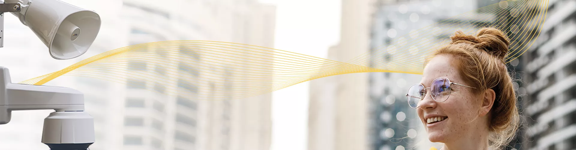 woman smiling in the foreground, big skyscrapers in the background