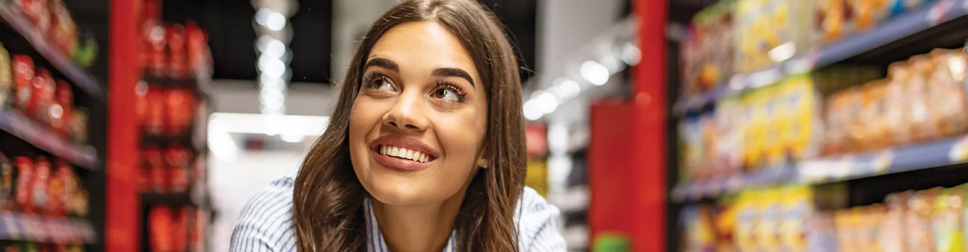 Smiling person with brown hair in grocery store