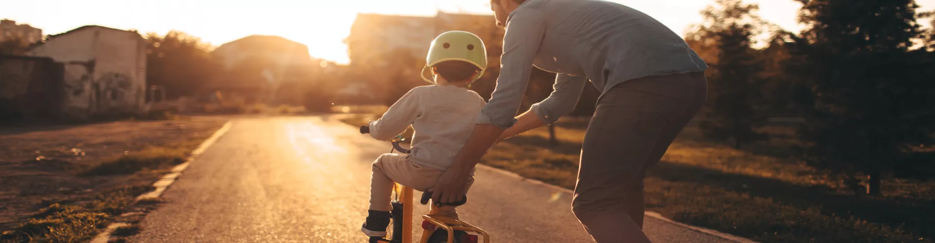 A father teaching his son how to ride the bike
